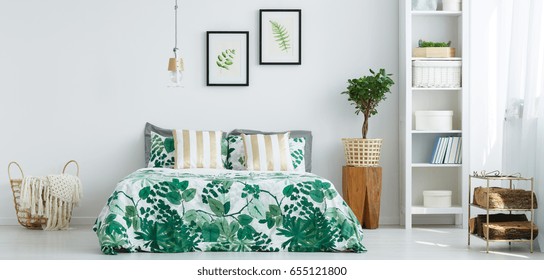 Bright stylish bedroom with plant patterned bedding