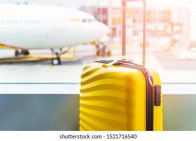 The bright and stylish cabin size suitcase in the airport, holiday concept. Easy travel with little baggage - Shutterstock ID 1521716540