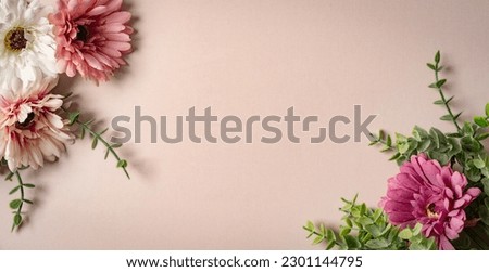 Bright summer background with pink, purple and white gerbera flowers and green leaves on pink background, web banner