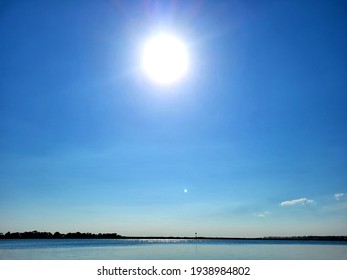 Bright Sun Beaming In A Clear Blue Sky Over The Ocean Horizon, Australia