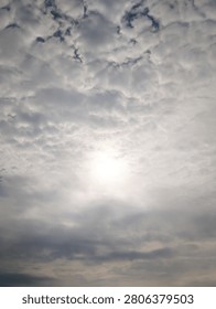 The bright sun pierced through the layer of clouds enveloping the sky.