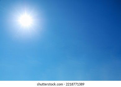 bright sun shines on clear blue sky.