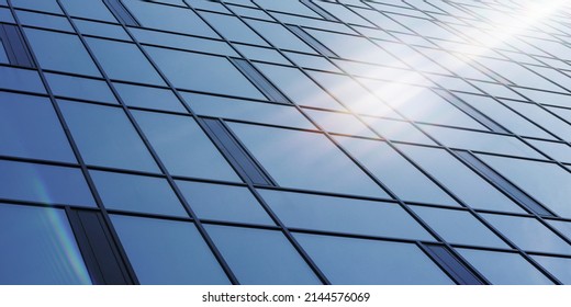 Bright Sun Shines On Large Corporate Building Wall With Panoramic Windows Reflecting Blue Skyscape On Summer Day