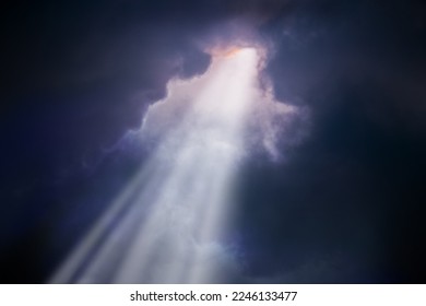 A bright sunbeam breaks through the dark clouds. Concept of hope - Shutterstock ID 2246133477
