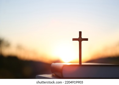 Bright sunlight, bible and holy jesus christ cross silhouette
 - Shutterstock ID 2204919903
