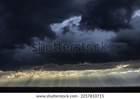 Bright sunrays cut through dark, ominous storm clouds hovering over midtown Atlanta