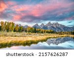 A bright sunset sky over the Three Tetons in Grand Teton, Wyoming