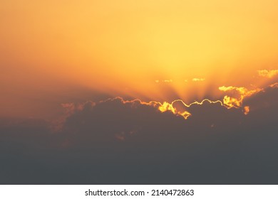 bright sunset or sunrise sky with clouds and sunrays