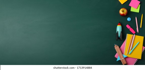 Bright toy rocket and school supplies on chalkboard, flat lay with space for text. Banner design - Shutterstock ID 1713914884