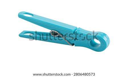 Bright turquoise plastic clothes peg with metal spring mechanism
