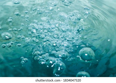 The Bright Turquoise Water Has Many Bubbles, Giving It A Refreshing And Tingling Sensation.