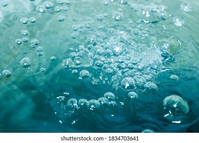 The Bright Turquoise Water Has Many Bubbles, Giving It A Refreshing And Tingling Sensation.