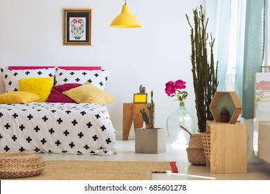 Bright Unique Bedroom With Plants, Rug, Poster And Colorful Pillows