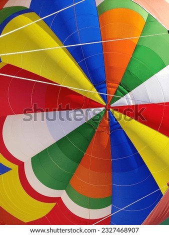Bright and vibrant multicolored inside of the top crown of a hot air balloon.