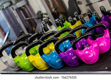 A Bright And Vibrant Set Of Kettlebells In A Gym.