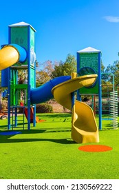 Bright warm sunny morning. Safe and cosy children 's playground with a variety of multicolored attractions. Open sun lawn for kids. Concept of physical and mental development of children
