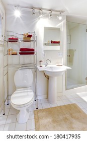 Bright White Bathroom With Metal Mobile Shelf Storage Unit