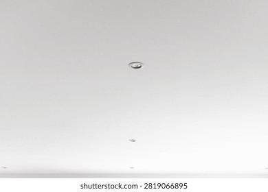A bright white ceiling with multiple recessed spotlights, creating a contemporary and uncluttered atmosphere for any home or office
