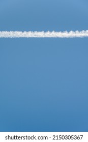 Bright White Contrail Cloud Against A Clear Blue Sky, As A Graphic Background
