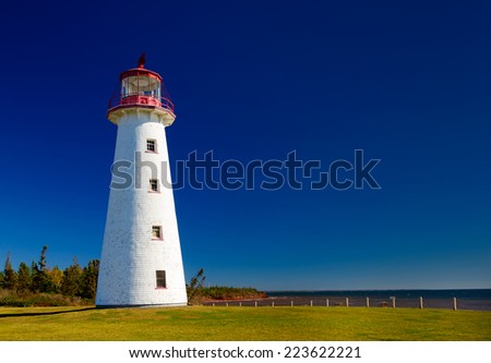 Bright white Lighthouse against deep blue sky
