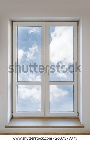 Bright white PVC window featuring double insulated panes showcases clear skies. This element enhances the comfort and energy efficiency of a modern apartment. Living room or bedroom interior