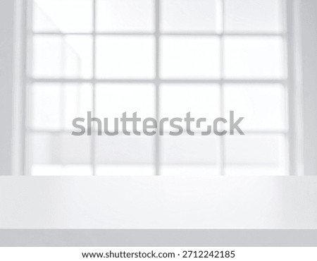 A bright white table surface in front of a large window with many panes.