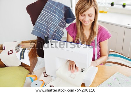 Bright woman sewing at home in the kitchen
