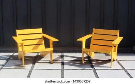     Bright Wooden Chairs On Large Stone Pavers, Ultra Modern Or Mid Century Modern                           