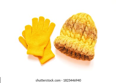 Bright yellow accessories for fall and winter season. Woolen gloves and knitted hat. Flat lay photography women's clothes