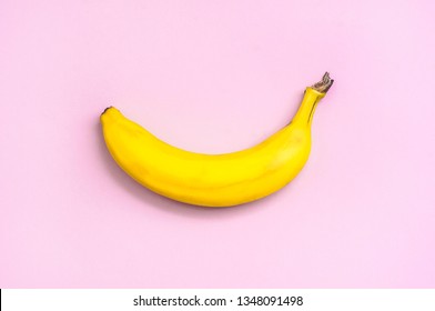 Bright yellow banana on a pink background. Top view - Powered by Shutterstock