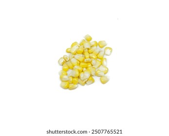 Bright yellow corn kernels are scattered on a clean white surface.