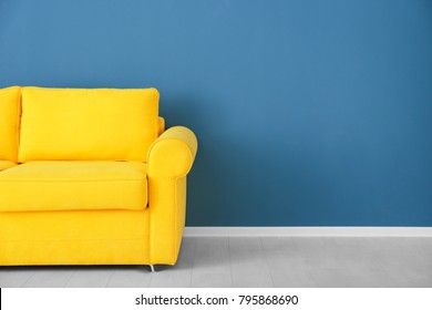Bright Yellow Couch Near Color Wall