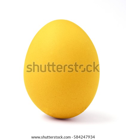 A yellow Easter egg with bunny ears from a napkin on a plate. Top view.