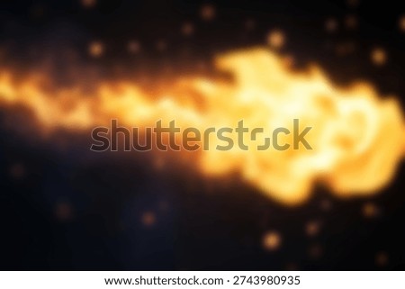 A bright yellow fire explodes in the darkness.. blurred background.