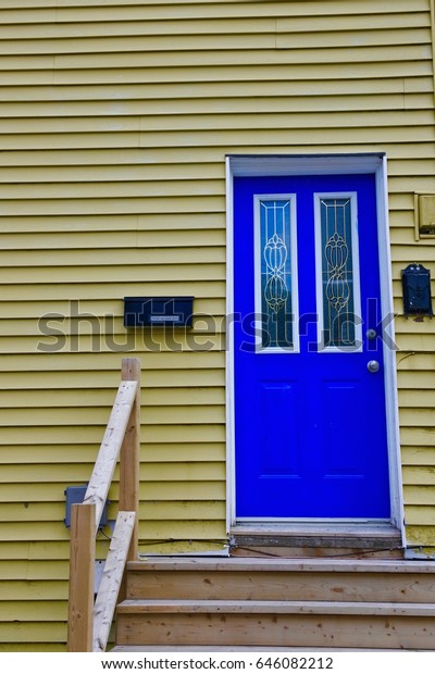 Bright Yellow House Blue Door St Royalty Free Stock Image