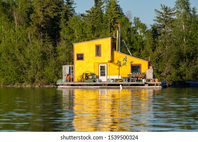 A Bright Yellow Houseboat At The Yellowknife Bay