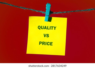 Bright yellow note featuring text regarding quality and price hangs on a simple blue wooden clothespin connected to a rope line against a smooth red surface
