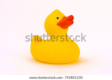 Bright yellow rubber duck with orange beak on a white background.
