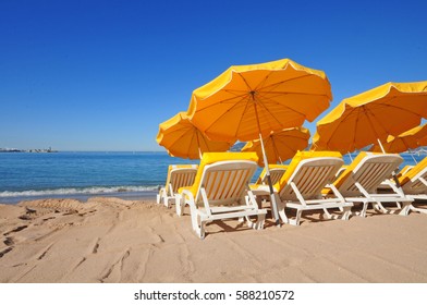 Bright yellow umbrellas on a beach on a summer day