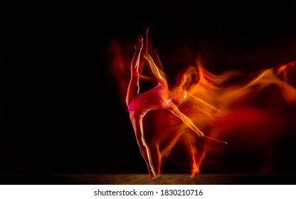 Bright. Young flexible girl isolated on black studio background in mixed light. Female rhythmic gymnastics artist practicing in action. Exercises for flexibility, balance. Grace in motion, sport.