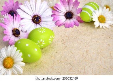 Bright-colored flowers and green Easter eggs as a border on rustic natural paper or parchment, with copysace - Powered by Shutterstock