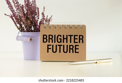 Brighter Future Text On Notepad On Office Desk. Business Concept