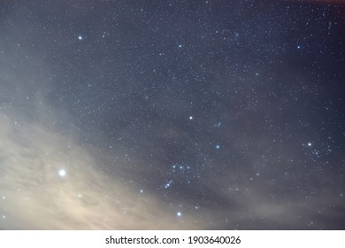 The brightest star Sirius near the constellation Orion in the foggy night.