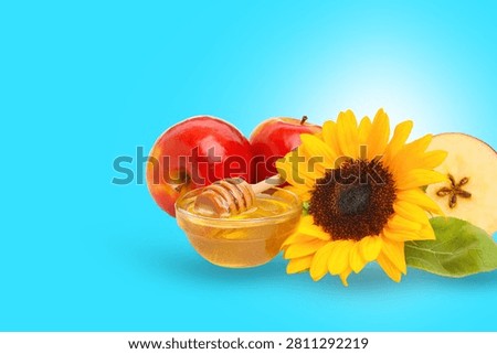 Brightly colored apples and honey complement a sunflower on display