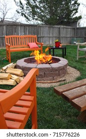 Brightly colored benches arranged around a backyard fire pit