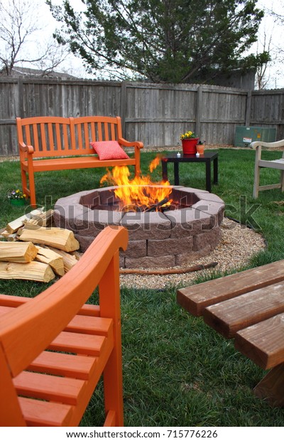 Brightly Colored Benches Arranged Around Backyard Stock Image