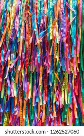 Brightly colored Brazilian wish ribbons in a full frame abstract textured background