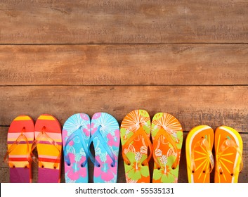 Brightly colored flip-flops on wood - Powered by Shutterstock