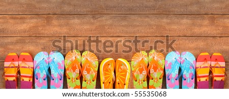 Brightly colored flip-flops on wood deck