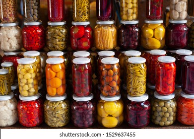 Brightly colored jars of Turkish Turşu, pickled vegetables for sale in an Istanbul Bazar, Turkey.